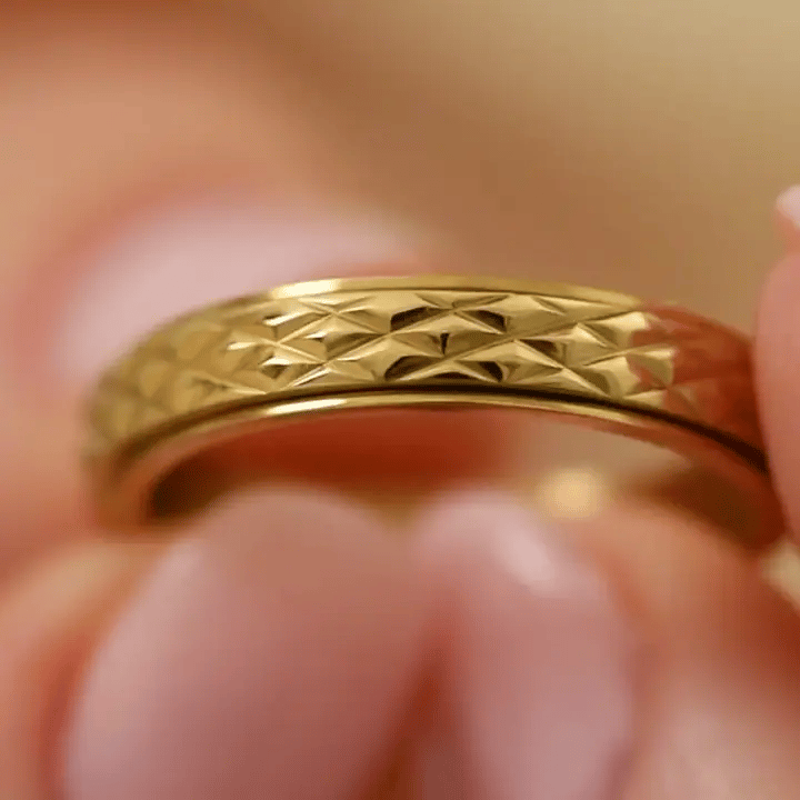 gold spinning cross pattern ring
